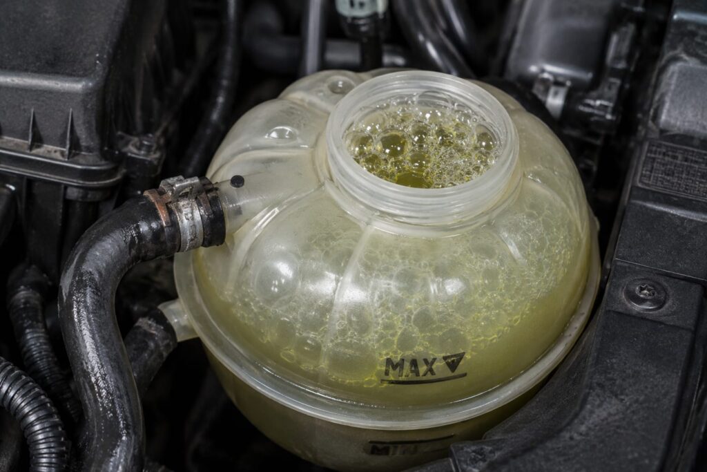 Coolant reservoir with visible bubbling, engine bay setting
